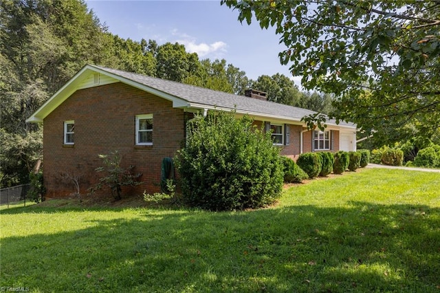 view of side of home featuring a yard