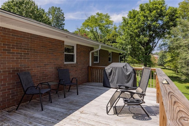 wooden deck featuring area for grilling