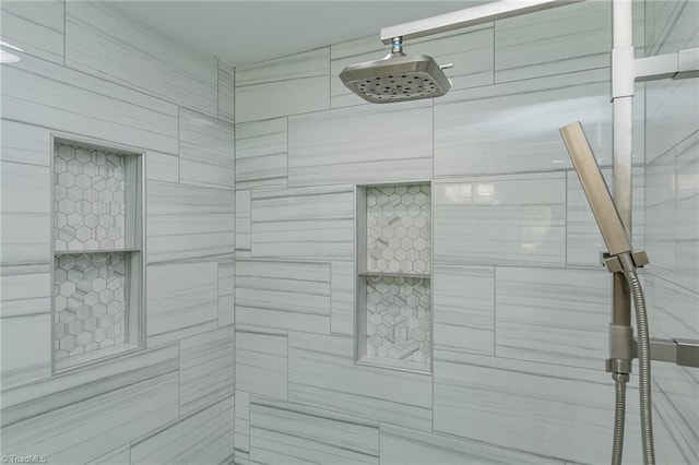 bathroom with a tile shower