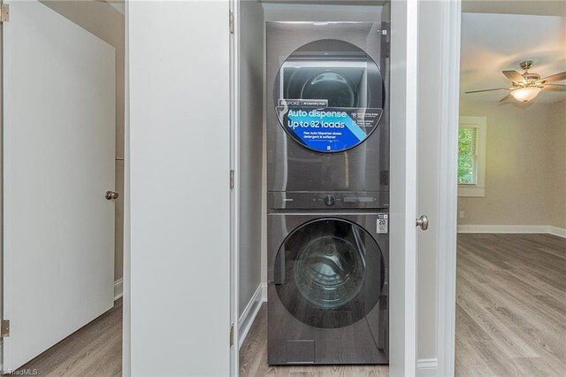 laundry area with stacked washer and dryer, ceiling fan, and light hardwood / wood-style floors