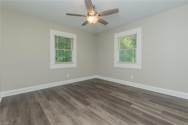 empty room featuring ceiling fan and dark hardwood / wood-style floors