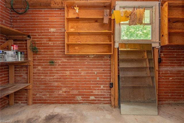 interior space featuring brick wall