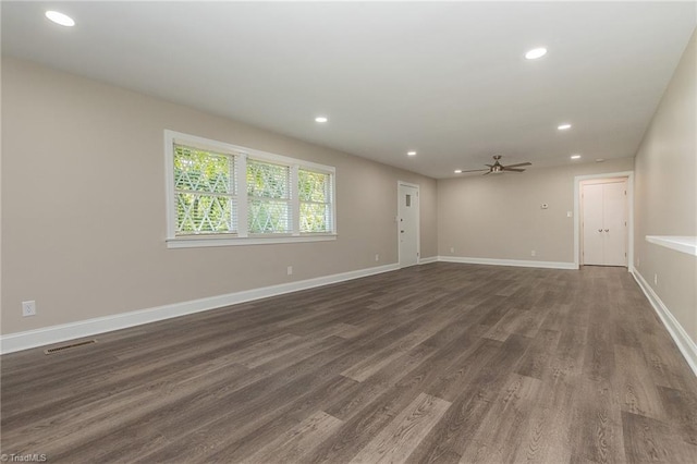 spare room with dark wood-type flooring and ceiling fan