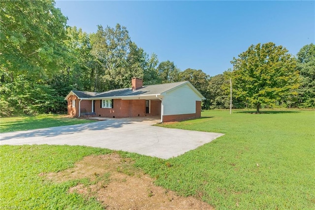 back of property with a lawn