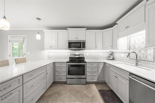 kitchen featuring appliances with stainless steel finishes, a sink, decorative backsplash, ornamental molding, and white cabinets