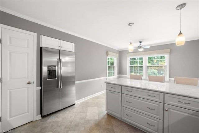 kitchen featuring stainless steel fridge, ornamental molding, ceiling fan, pendant lighting, and baseboards
