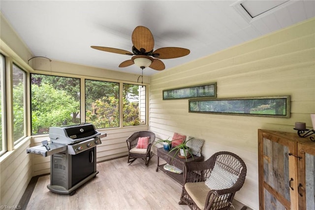sunroom / solarium featuring healthy amount of natural light and a ceiling fan