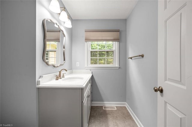 bathroom featuring vanity and baseboards