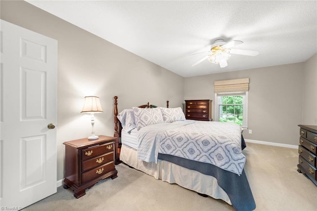 bedroom featuring light carpet, baseboards, and a ceiling fan