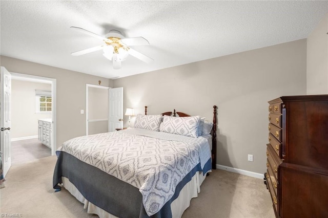 bedroom with light colored carpet, baseboards, a textured ceiling, and ceiling fan