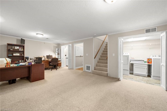 office featuring ornamental molding, washing machine and clothes dryer, a textured ceiling, and light colored carpet