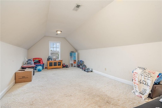 playroom featuring vaulted ceiling and carpet