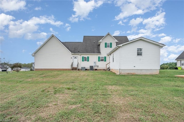 back of house with central AC and a yard