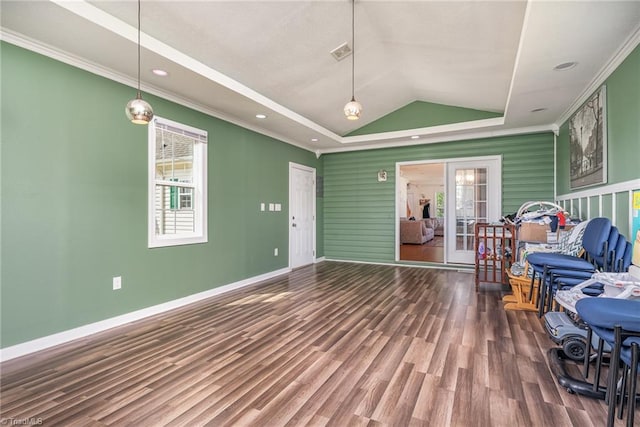 living room featuring hardwood / wood-style floors, lofted ceiling, ornamental molding, a tray ceiling, and french doors