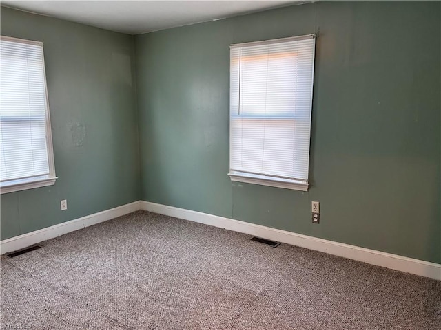 carpeted empty room with a healthy amount of sunlight