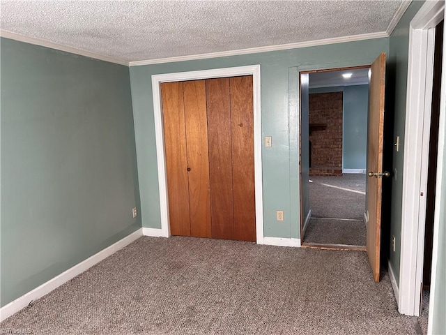 unfurnished bedroom featuring crown molding, carpet floors, a textured ceiling, and a closet