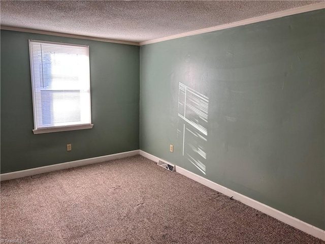 spare room with carpet, a textured ceiling, and ornamental molding