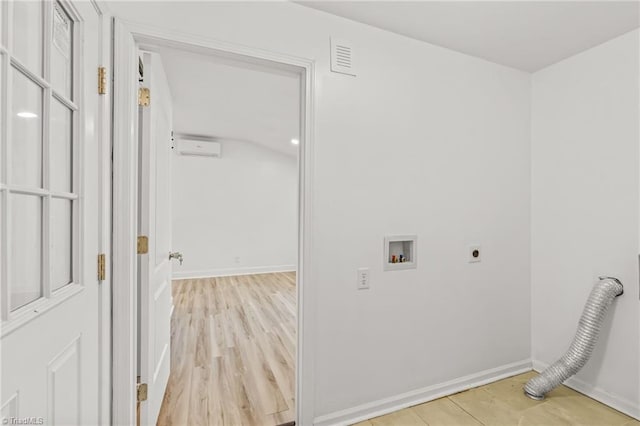 washroom featuring washer hookup, electric dryer hookup, and light hardwood / wood-style floors