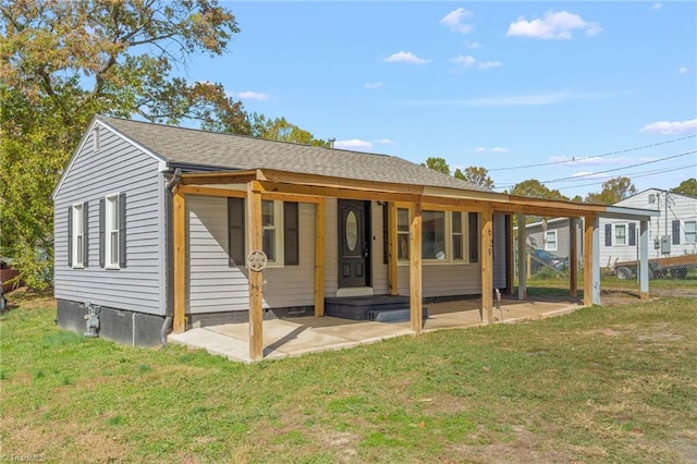 back of property featuring a lawn and a patio