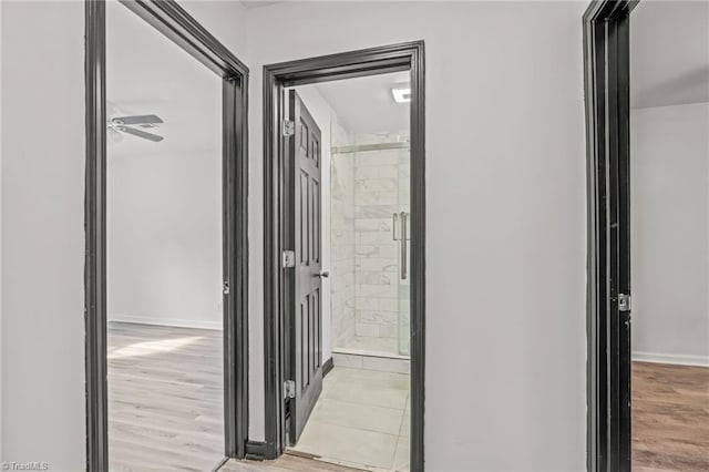 hallway with light hardwood / wood-style flooring