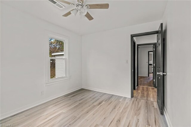 spare room with light hardwood / wood-style flooring and ceiling fan