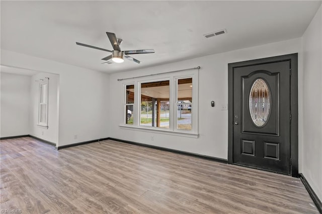 foyer with ceiling fan and light hardwood / wood-style flooring