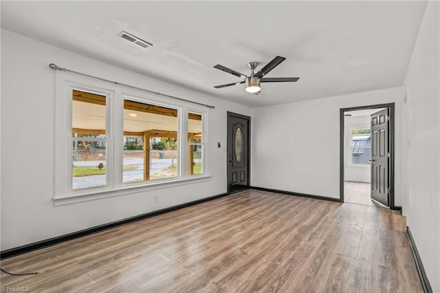 spare room featuring ceiling fan and light wood-type flooring