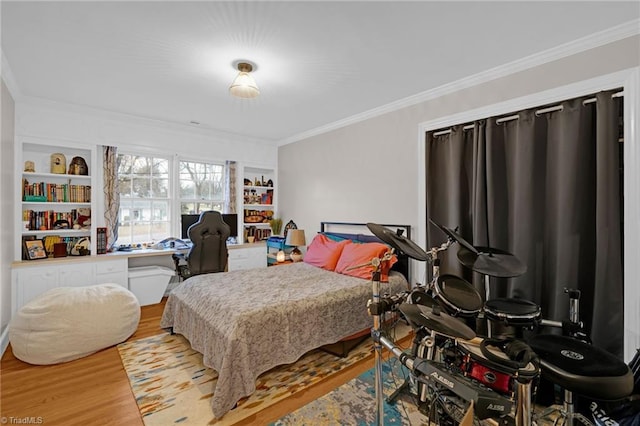 bedroom with wood-type flooring and crown molding