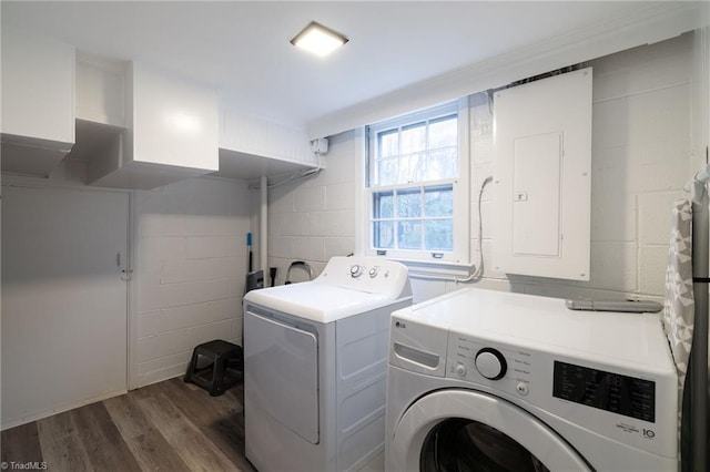 washroom featuring washer and dryer, electric panel, and dark wood-type flooring