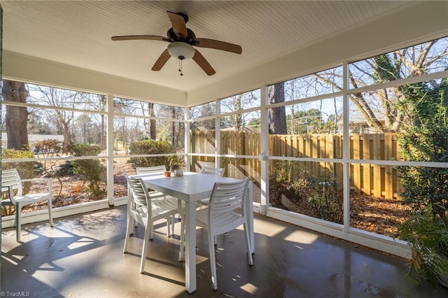 unfurnished sunroom featuring ceiling fan