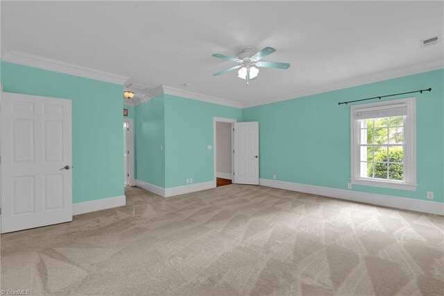 unfurnished bedroom with ceiling fan, visible vents, crown molding, carpet floors, and baseboards