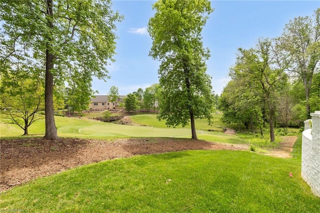 view of community featuring a yard and golf course view