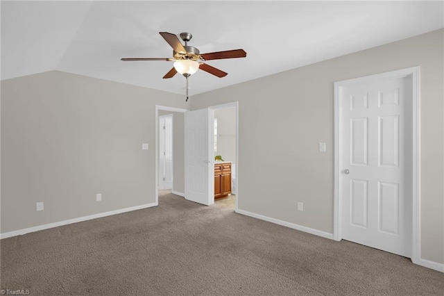 carpeted empty room with ceiling fan and lofted ceiling