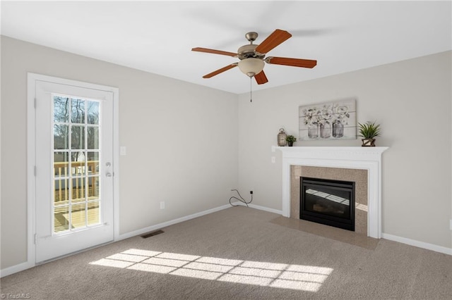 unfurnished living room with ceiling fan and carpet flooring