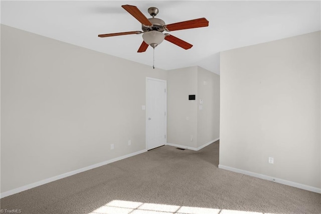 spare room with light colored carpet and ceiling fan