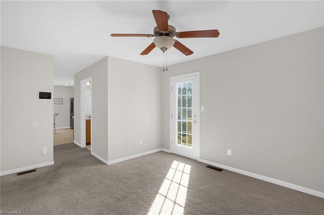 unfurnished room with ceiling fan and carpet floors