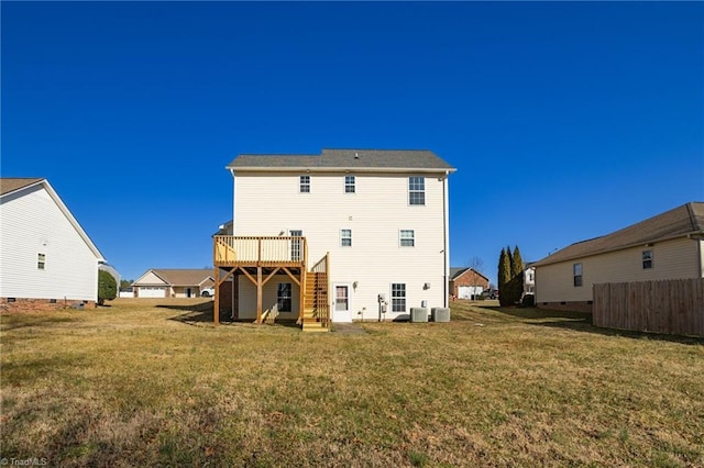 rear view of property featuring cooling unit, a yard, and a deck