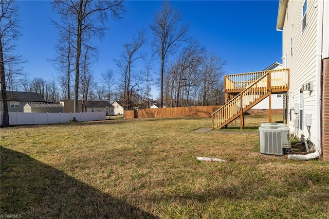 view of yard with a wooden deck and central AC