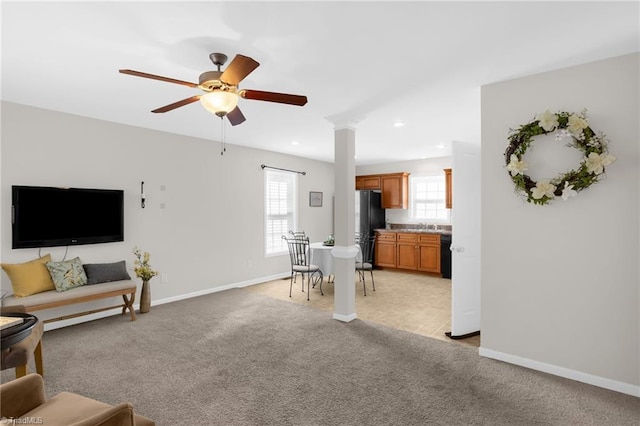 living room featuring ceiling fan and light colored carpet