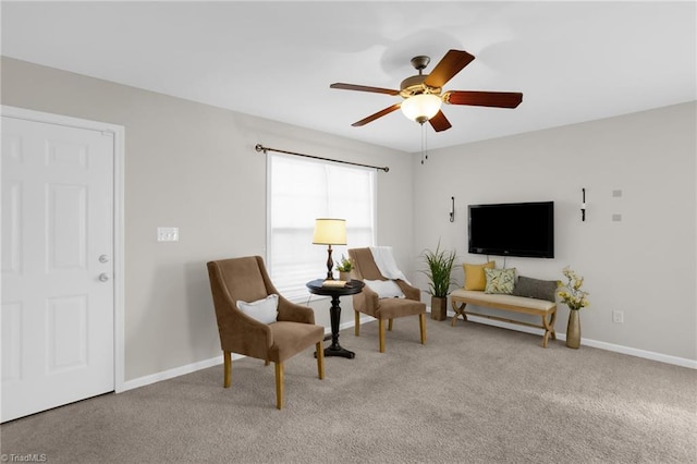 sitting room featuring light carpet and ceiling fan