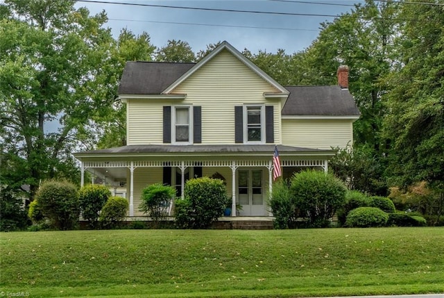 view of front of house featuring covered porch and a front yard