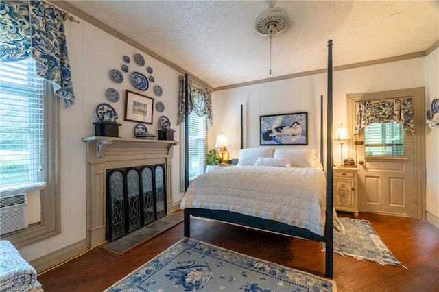 bedroom featuring multiple windows and dark hardwood / wood-style floors