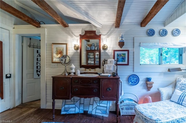 bathroom with wood-type flooring, beam ceiling, vanity, and wooden walls