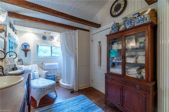 bathroom with wood-type flooring, vanity, and lofted ceiling with beams