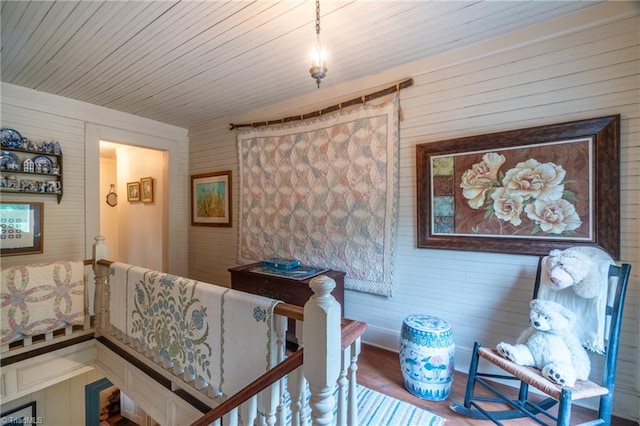 bedroom with wood-type flooring, wooden ceiling, and wooden walls