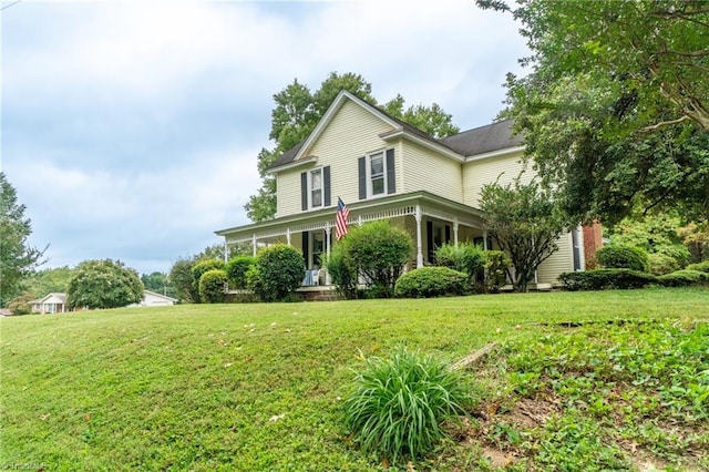 view of front of house with a porch and a front lawn