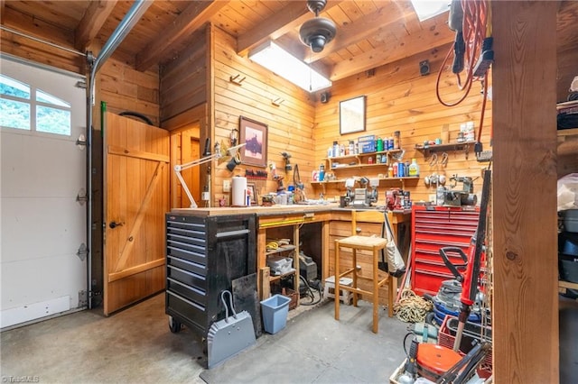 garage with wooden walls, a workshop area, and wood ceiling