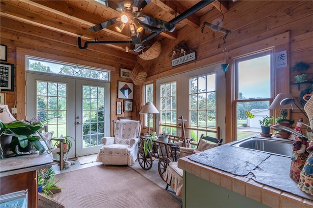 interior space featuring beamed ceiling, sink, ceiling fan, wooden ceiling, and french doors