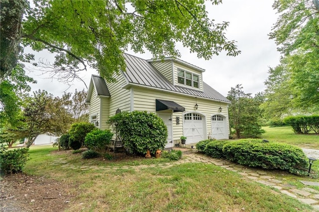 view of home's exterior featuring a lawn and a garage