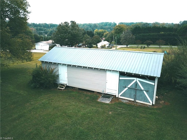 view of outdoor structure with a lawn